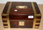 An early Victorian rosewood and brass bound box, the hinged lid with recessed handle, enclosing a fitted interior.