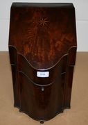 A George III figured mahogany knife box, the sloping hinge lid and serpentine front with chequer banding (lacking interior).
