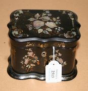 A Victorian papier-mâché tea caddy of serpentine rectangular form, with inlaid mother-of-pearl and gilt decoration, the hinged lid revealing a single lidded compartment, width approx 15cm.