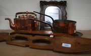 A carved wood spoon, a spinning shuttle, a small group of copper items and a mirror.