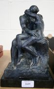 After Auguste Rodin - The Kiss, a late 20th Century cast model of the embracing couple, with facsimile signature, on a slate base.