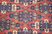 A Turkestan carpet, circa 1900, the pale plum field with overall offset rows of stylized guls, within a hooked gul border, approx 390cm x 200cm.