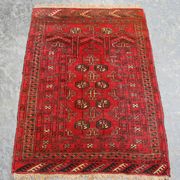 A Tabriz carpet, North-west Persia, mid-20th Century, the deep red field with overall palmettes and scrolling vines, within an ivory palmette border, approx 412cm x 300cm.