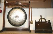 An Edwardian gong on an oak stand, together with a coal scuttle.