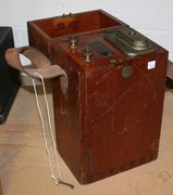 A Siebe Gorman & Co dynamo electric detonator, the wooden case with a leather carrying handle.