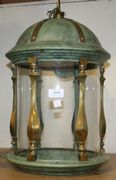 A brass, verdigris metal and glass ceiling light of cylindrical form with dome top.