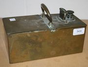 A late 19th/early 20th Century brass honesty box with carrying handle and two lidded compartments (minor faults, lacking one foot).