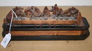 A late 19th Century Continental carved softwood figure group of The Last Supper, on an ebonized octagonal base, inscribed 'Amen Dico Vobis Quia Unus Vestrum Me Traditurus Est', width approx 31cm.