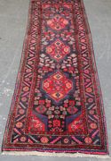 A Hamadan runner, North-west Persia, late 20th Century, the deep blue field with floral medallions supported by guls, within a stepped leaf and flowerhead border, approx 306cm x 100cm.