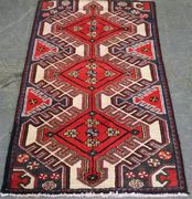 A Hamadan rug, North-west Persia, modern, the ivory field with three linked medallions supported by polychrome guls, within a thin blue and claret border, approx 148cm x 82cm. 