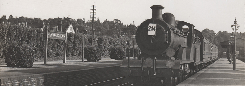  A photographic postcard of a train at Haywards Heath railway station, published by H.C. Casserley of Berkhamsted 