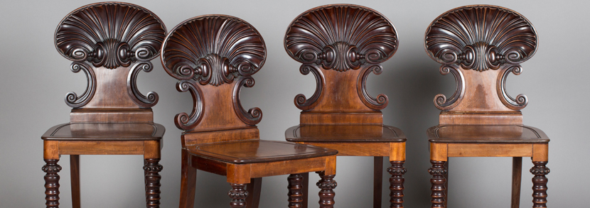 An impressive set of four Regency mahogany shell back hall chairs, in the manner of Gillows of Lancaster