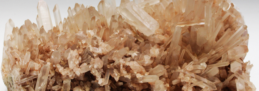 A large quartz crystal cluster specimen of pink tone