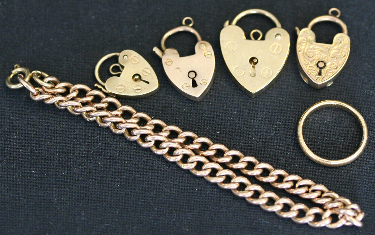 Four 9ct gold heart shaped padlock clasps, a 9ct gold curblink bracelet ...
