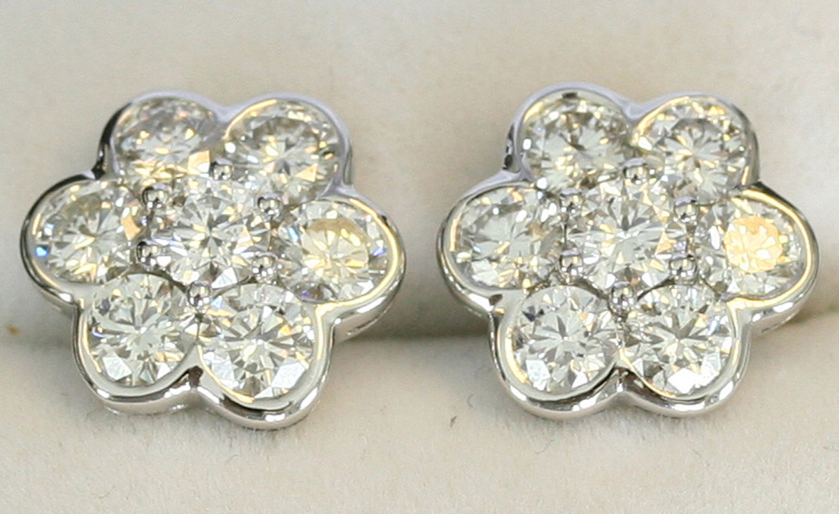A pair of diamond set seven stone cluster earstuds, mounted with ...