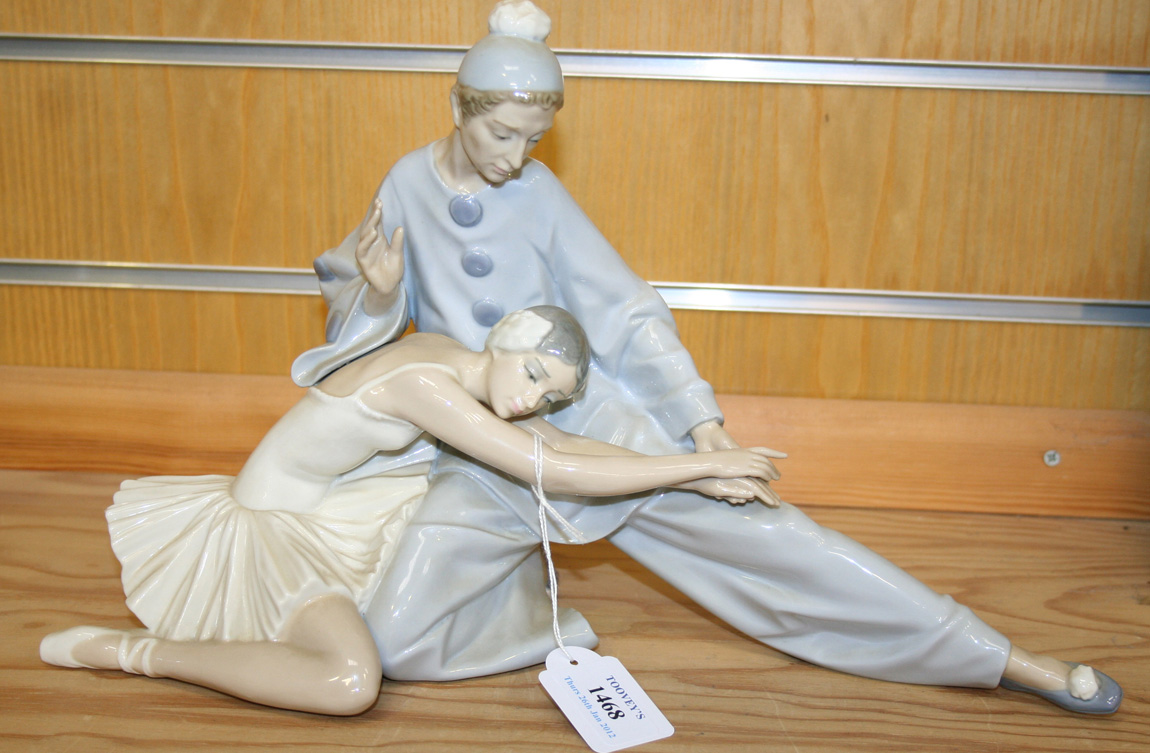 A Lladro porcelain figure group of a Pierrot dancing with a ballerina, blue  printed factory mark to