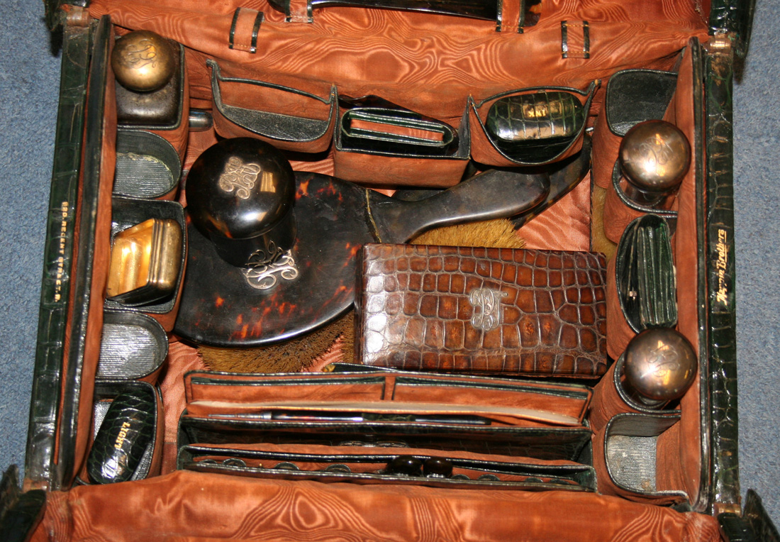 A late Victorian dark green crocodile skin Gladstone bag by Mappin  Brothers, partially fitted with f