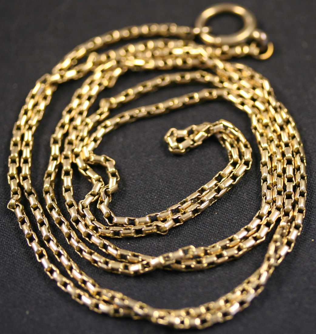 A gold rectangular link long guard chain with boltring clasp.