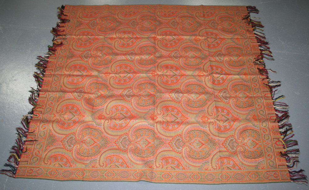 An early 20th Century Paisley design woven shawl, decorated with an ...