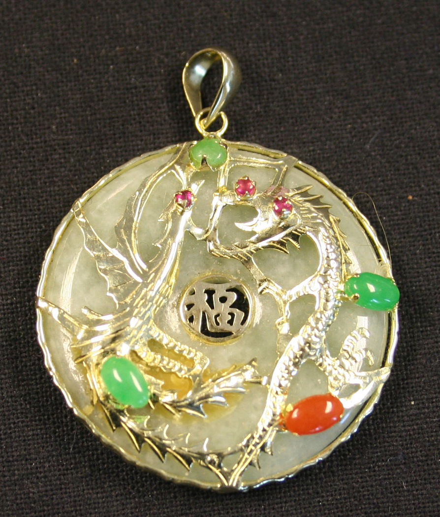 A Ct Gold Mounted Circular Jade Pendant The Front With A Gem Set