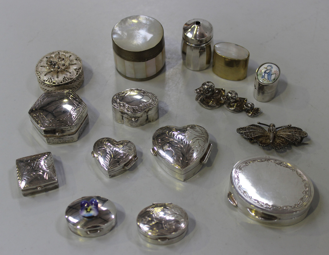 A small group of modern silver pill boxes and other various pill