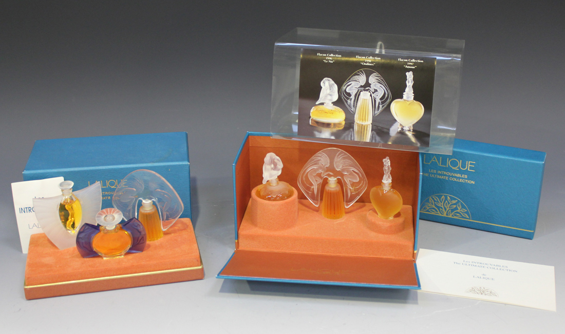 A set of three boxed miniature perfume bottles by Lalique The
