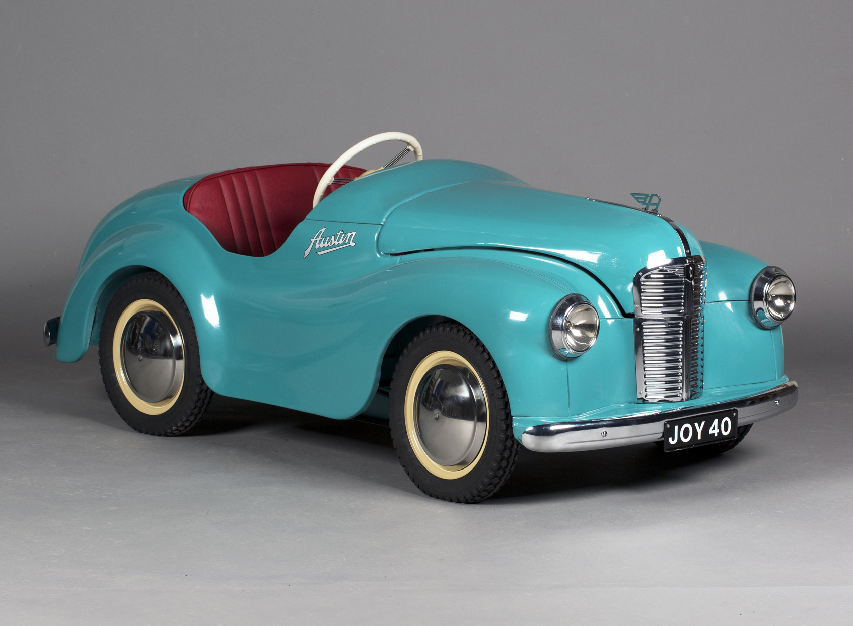 An Austin J40 pedal car, finished in turquoise with later chrome flying 'A'  bonnet motif,