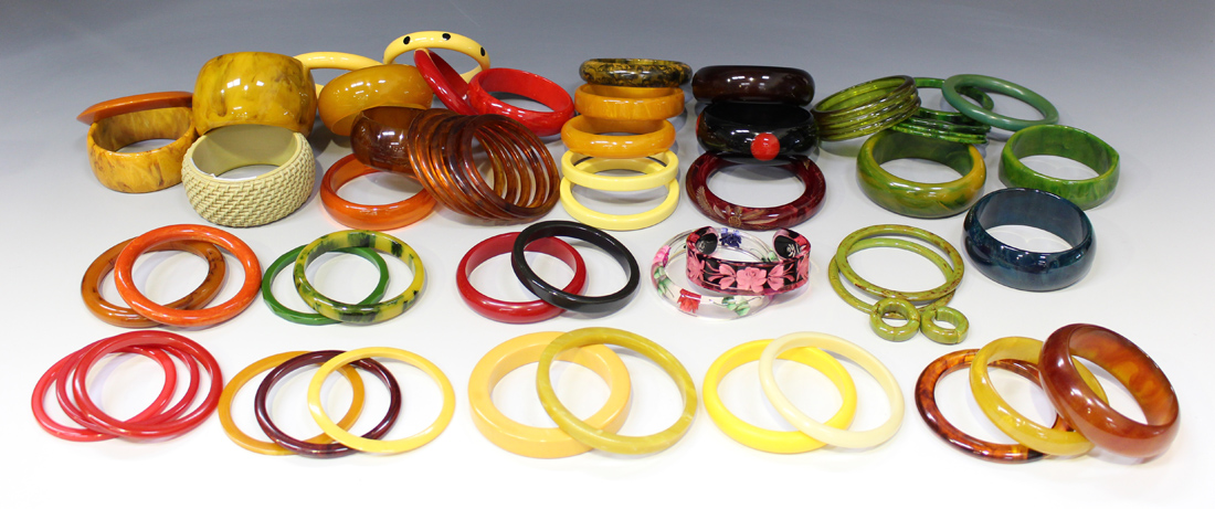 A collection of Bakelite bangles, including one with basket weave ...