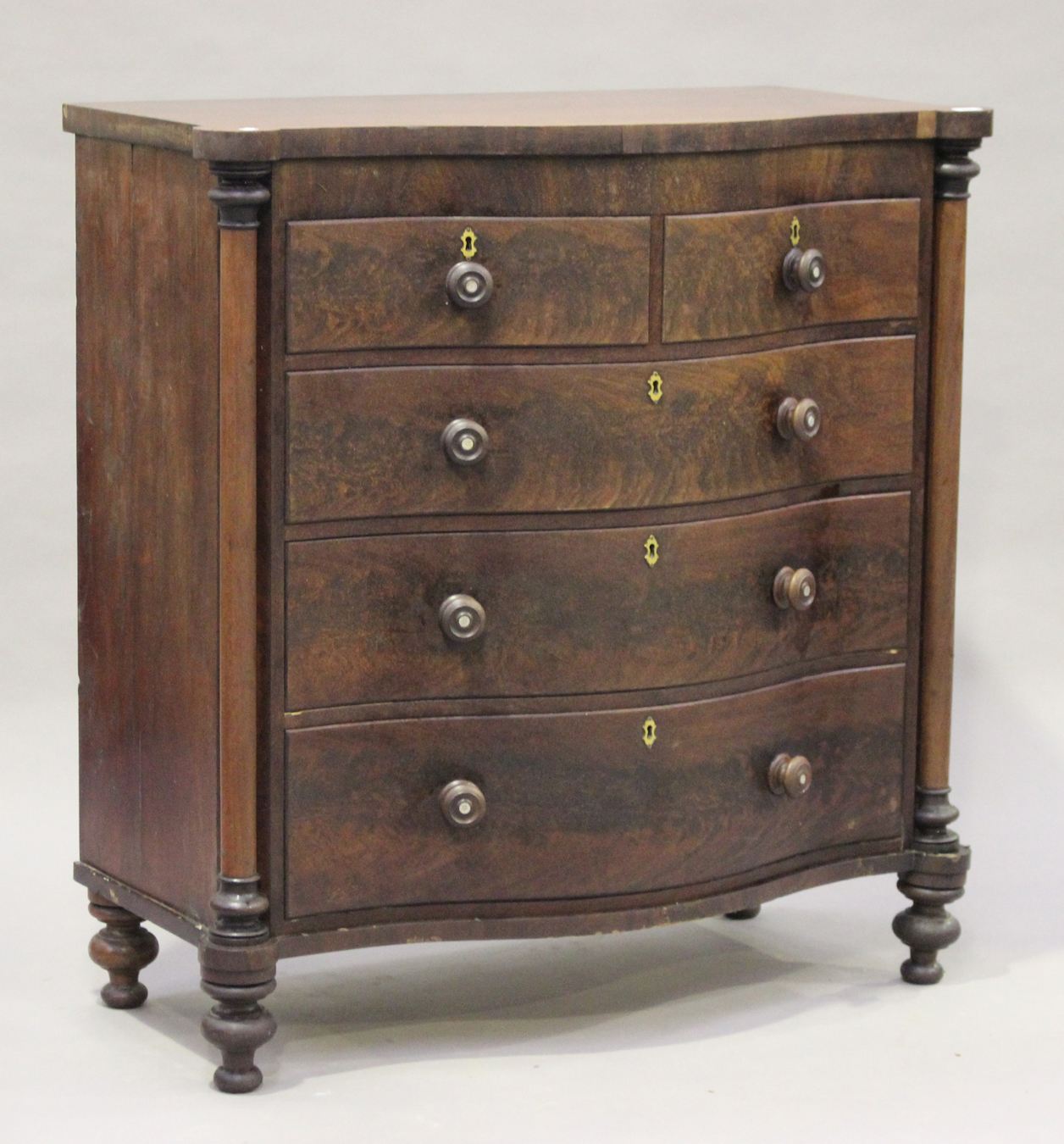A Victorian mahogany serpentine fronted chest of two short and three ...