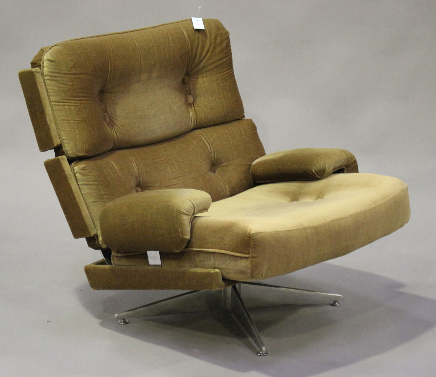 A mid-20th century revolving armchair by Howard Keith, upholstered in ...