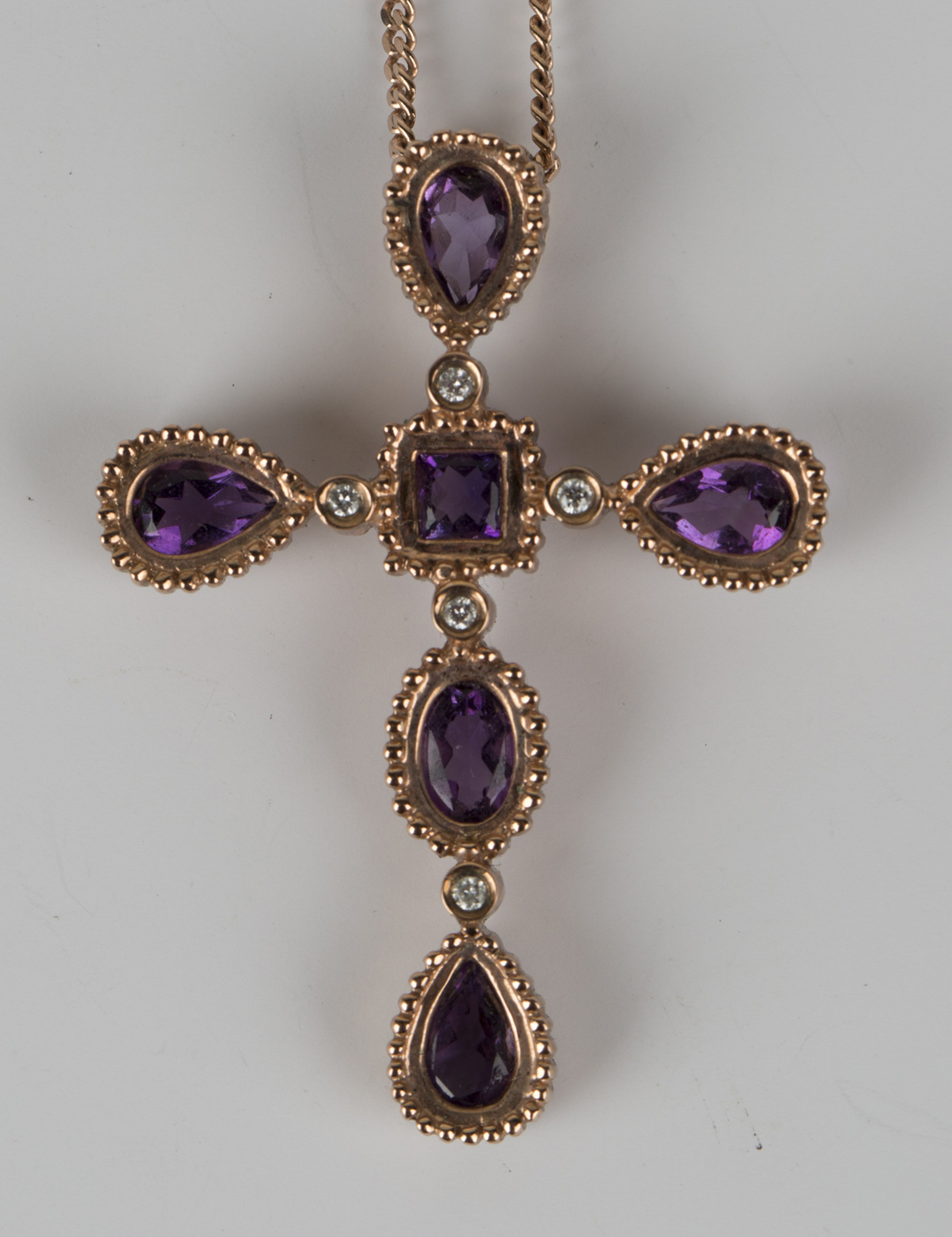 A Welsh Clogau 9ct gold, amethyst and diamond pendant cross with a ...