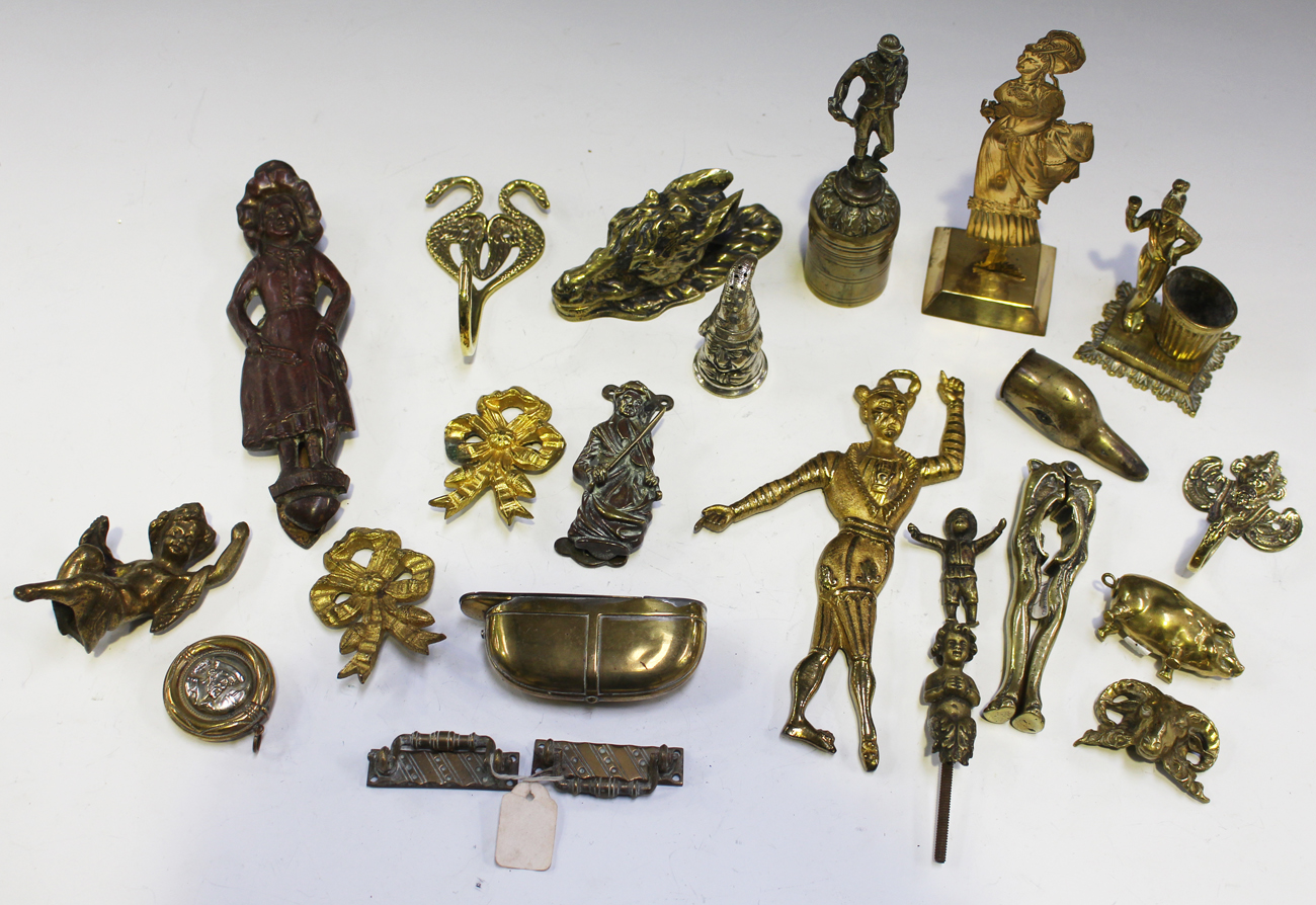 A collection of mainly 19th century novelty brass items, including an  engraved figural vesta holder