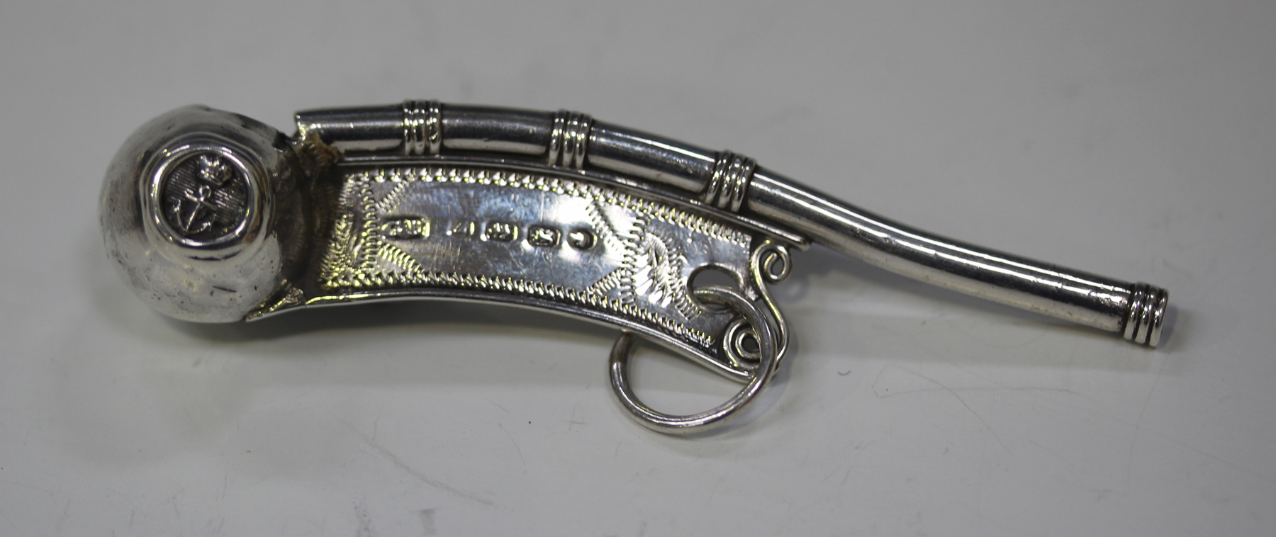 A Victorian silver boatswain's whistle with engraved decoration ...