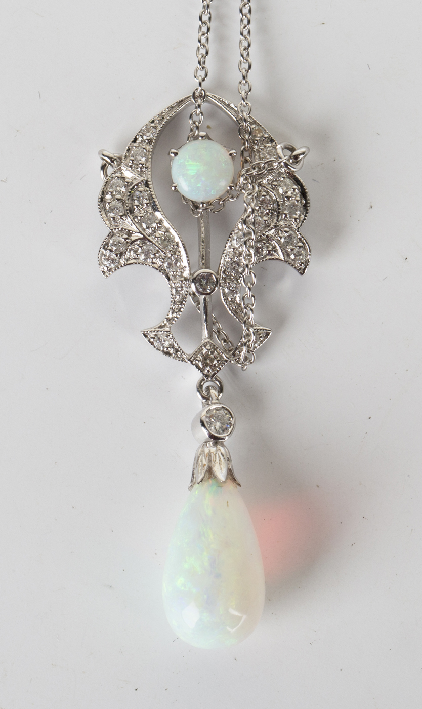 A white gold, opal and diamond pendant necklace of scrolling form ...