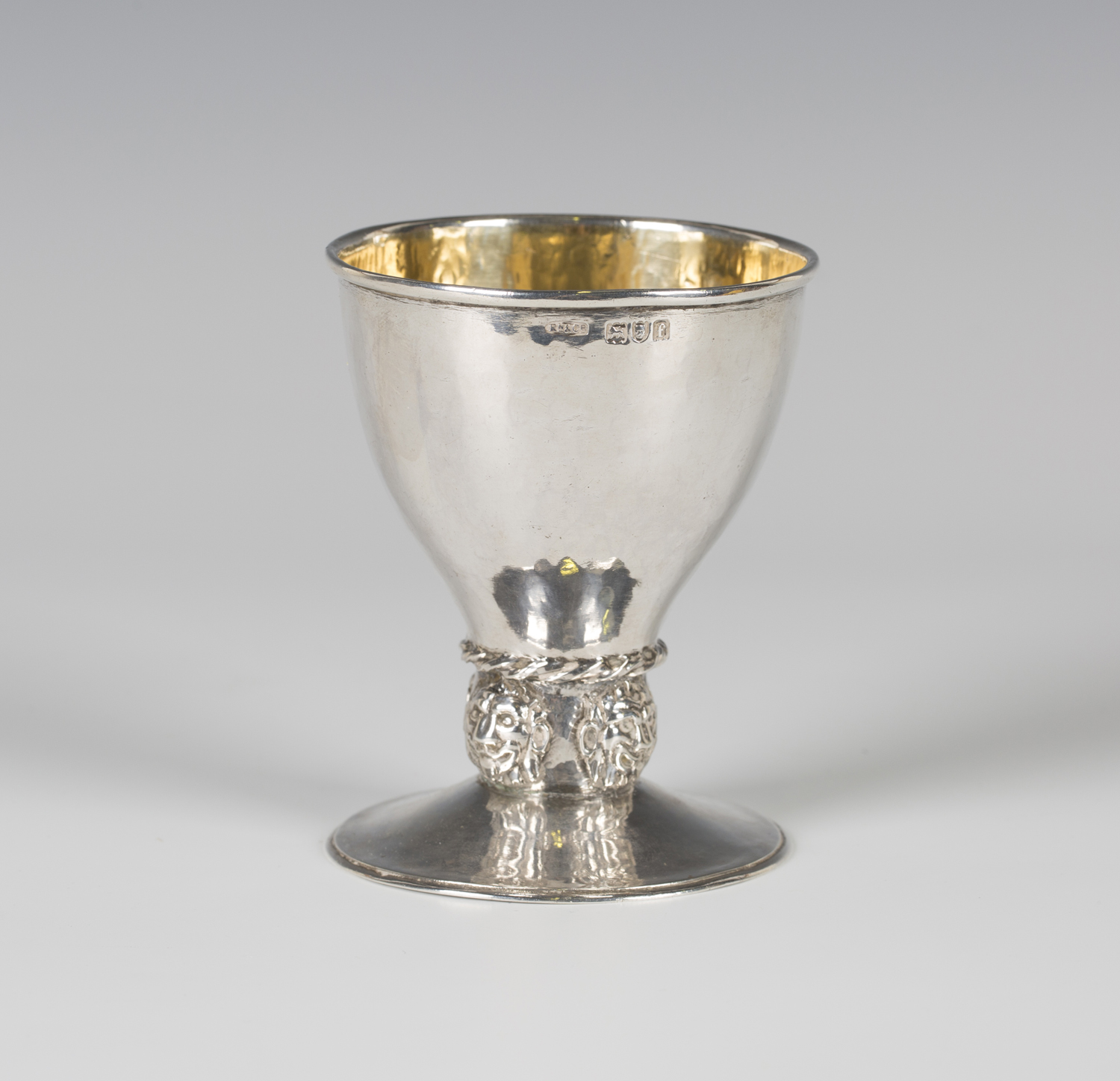 An Arts and Crafts silver goblet, the cylindrical tapering bowl above a ...