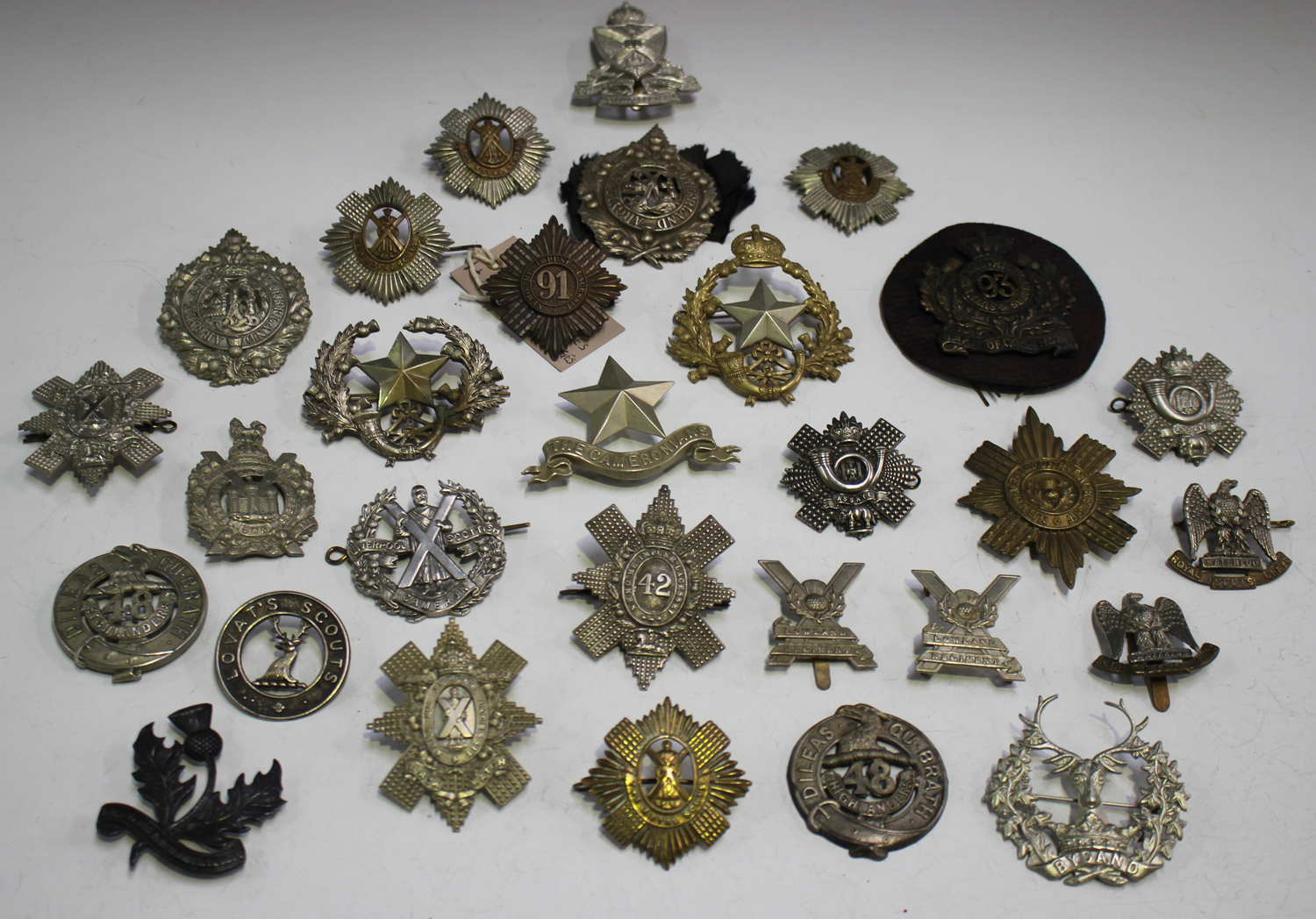 A large collection of various Scottish regimental badges, including ...