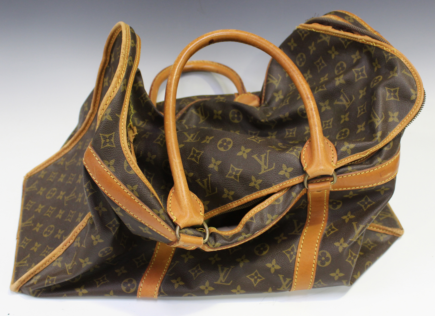 A Louis Vuitton shoe bag, the monogram canvas body with tan leather  trimming and handles, length 54c