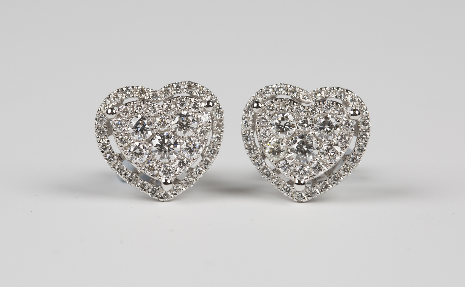 A pair of 18ct white gold and diamond heart shaped cluster earstuds ...