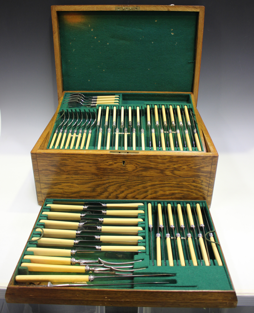 An Edwardian canteen of plated Old English pattern cutlery by