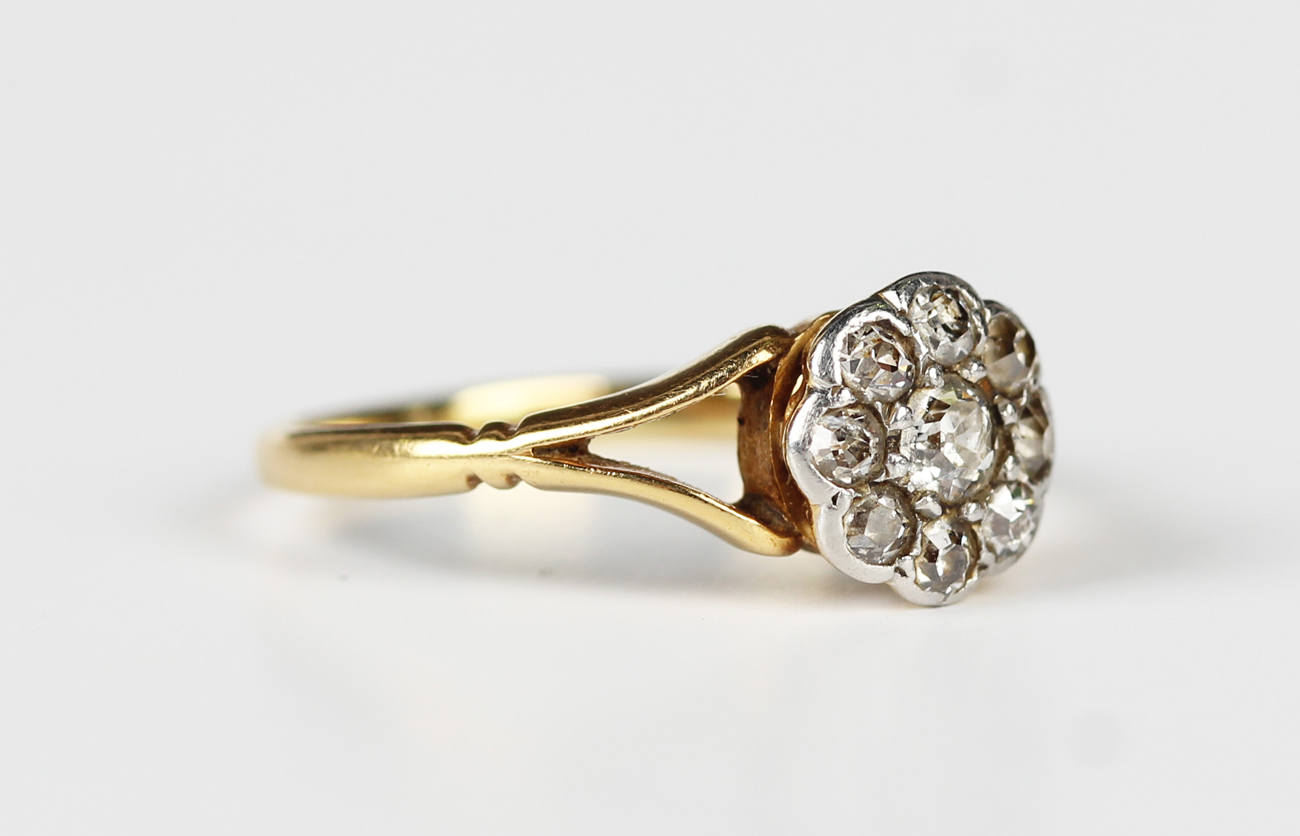 A gold and diamond nine stone cluster ring, mounted with cushion cut ...