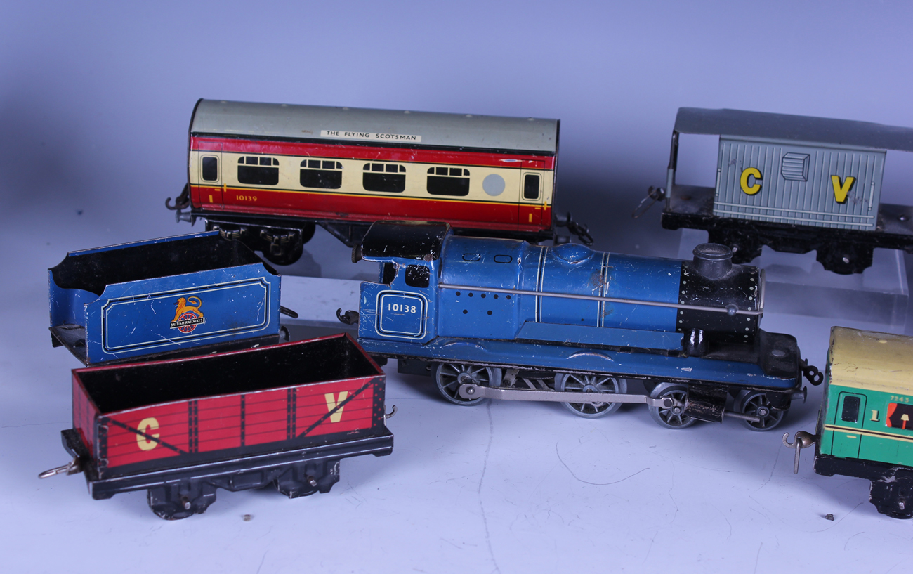 A collection of Chad Valley gauge railway items, including clockwork locomotive 10138 and tender