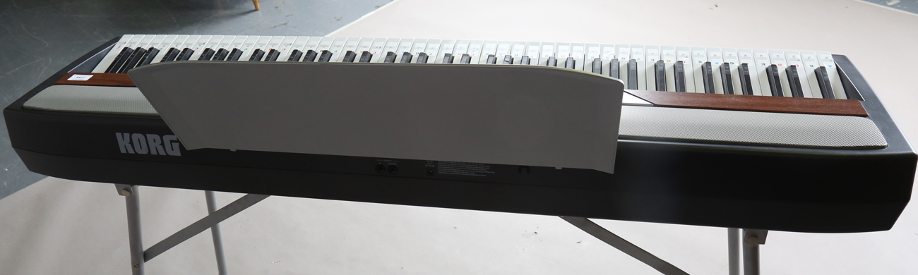 A Korg SP-250 electric keyboard, width 130cm, together with