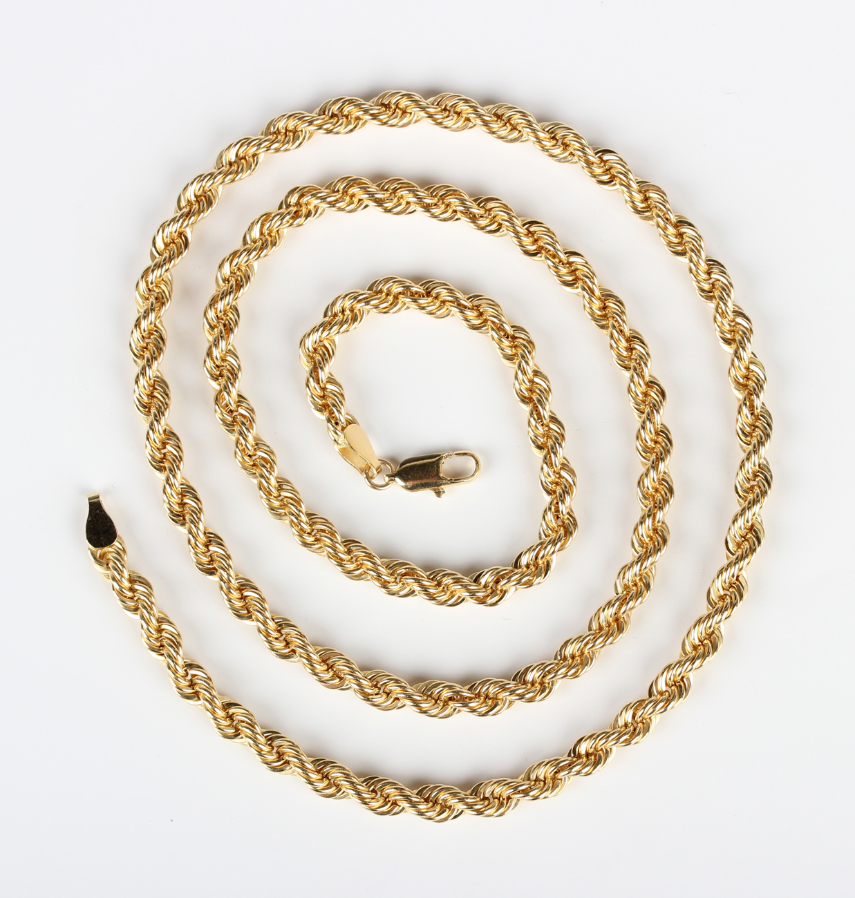 A gold ropetwist link neckchain on a sprung hook shaped clasp, detailed ...