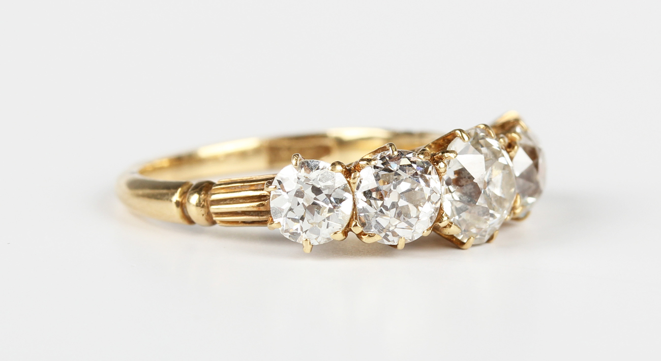 A late 19th century gold and diamond five stone ring, claw set with a ...