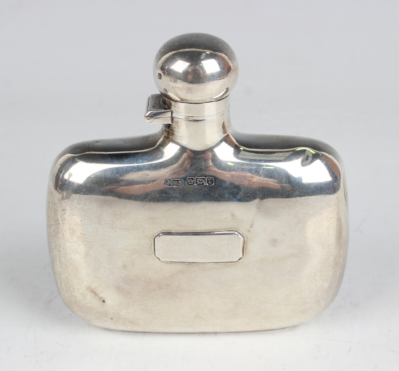 An Edwardian silver hip flask of curved oblong form with screw hinged ...