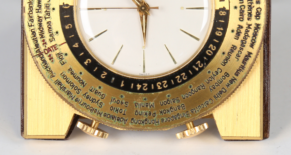 A Luxor brass cased world time travelling alarm clock, the signed